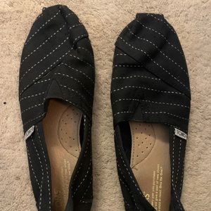 Tom’s womens black flats with white stitching
